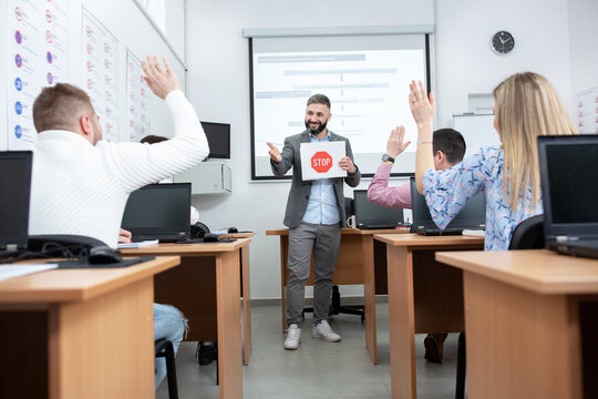 Driving instructor showing traffic signs drawn on paper