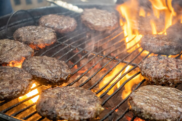 Juicy meat steaks cooked over charcoal on a wire rack. Meat cooked on a fire in the open air. Close-up.