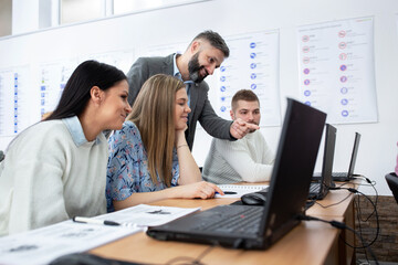 Driving theory teacher showing his students traffic rules, instructor concept