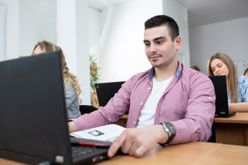 Fototapeta premium Young man attending university class