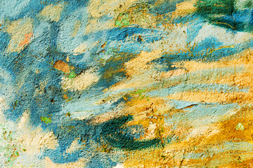 Abstract creative background of chaotic strokes of old cracked paint on concrete wall. Old surface with traces of paint, weathered, scratches and cracks for design