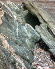 The green coloured rocks of Whitsand Bay Cornwall