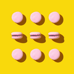 Regular creative pattern of colorful french cookies macarons. Greeting card for party or holiday.