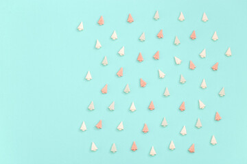 Pastel cute candy sweets, in form of Christmas trees. New year background in mint pink tones with copy space. Top view.