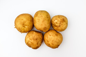 Raw potatoes on a white background