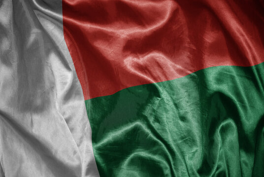 colorful shining big national flag of madagascar on a silky texture