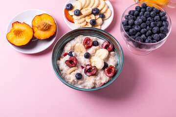porridge, fruit and berries as healthy yummy breakfast concept