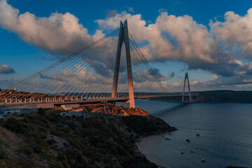 Fototapeta na wymiar Bosphorus Yavuz Sultan Selim Bridge, blue sky and white clouds.