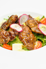 Grilled beef in a sauce with Dejon mustard and soft cheese in a case plate on a gray background.