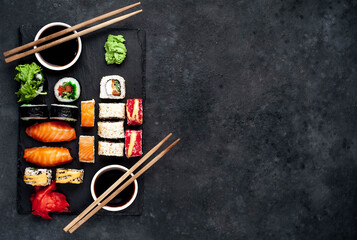 Fototapeta na wymiar Set of sushi on a stone background with copy space for your text