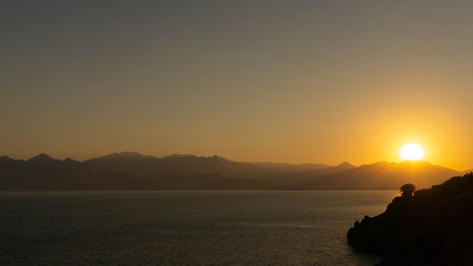 incredibly landscape of the setting sun against the backdrop of mountains