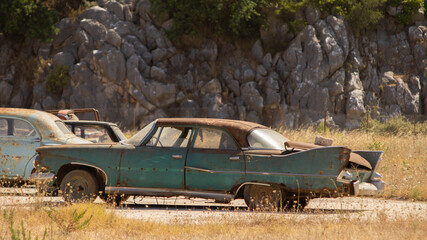 old vintage cars rust in the parking lot