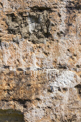 Abstract creative background of chaotic strokes of old cracked paint on concrete wall. Old surface with traces of paint, weathered, scratches and cracks for design