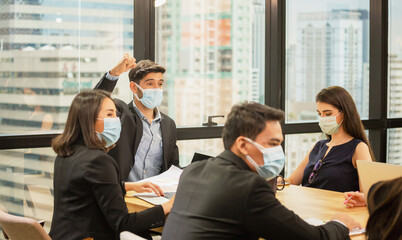 Success and Teamwork concept, Group of young business people wear protection face mask and meeting in office