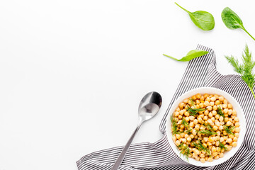 Vegetarian bowl with chickpeas and vegetables - white table top view copy space