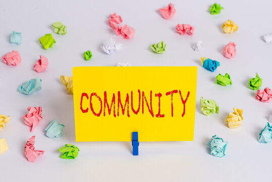 Handwriting text Community. Conceptual photo group of showing with a common characteristics living together Colored crumpled papers empty reminder white floor background clothespin