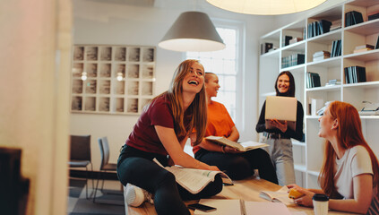 University friends studying together in library