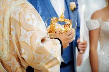 Close up of cristian priest hands with crown for wedding