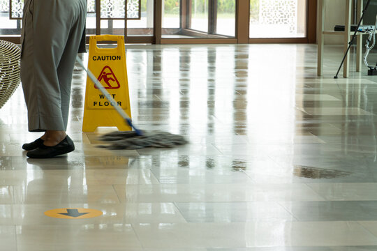 Mopping wet floor in lobby hotel. Background for caution wet floor.
