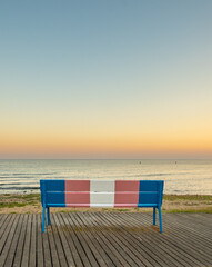 bench at sunset painted in the colors of transsexuality.