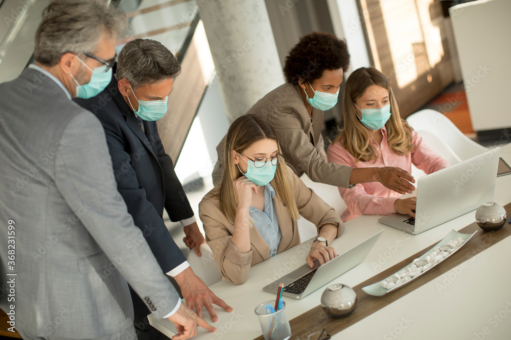 Wall mural group of business people have a meeting and working in office and wear masks as protection from coro