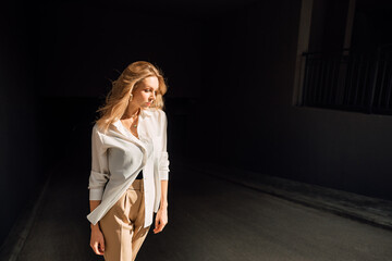 Portrait of beautiful young girl outdoors on hot, sunny, summer day, stylish happy woman walking around the city