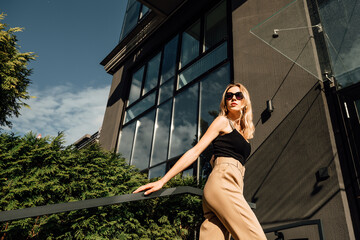 Portrait of beautiful young girl outdoors on hot, sunny, summer day, happy woman in sun glasses