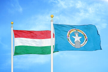 Hungary and Northern Mariana Islands two flags on flagpoles and blue cloudy sky