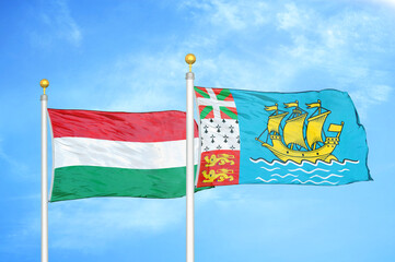 Hungary and Saint Pierre and Miquelon two flags on flagpoles and blue cloudy sky