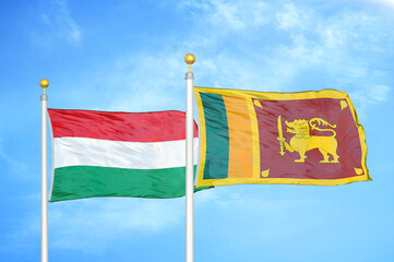 Hungary and Sri Lanka two flags on flagpoles and blue cloudy sky