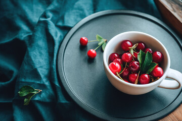 Ripe cherries in a mug. Good Morning Concept Cottagecore Aesthetics. Rustic, vintage style. Selective focus. Macro