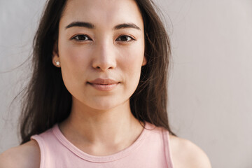 Fototapeta premium Image of young asian beautiful girl looking at camera