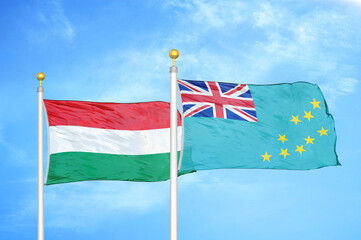 Hungary and Tuvalu two flags on flagpoles and blue cloudy sky
