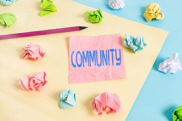 Conceptual hand writing showing Community. Concept meaning with a common characteristic or interest...