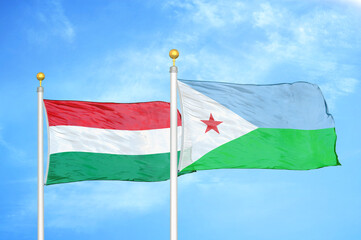 Hungary and Djibouti two flags on flagpoles and blue cloudy sky