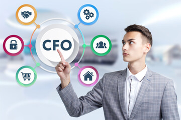 Business, Technology, Internet and network concept. Young businessman working on a virtual screen of the future and sees the inscription: CFO