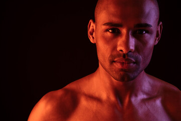 Fototapeta premium Fitness pleased man isolated over black wall background
