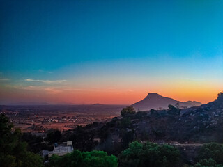 A view of a hill from another hill with beautiful clouds . It looks like the volcano hill © Aravind