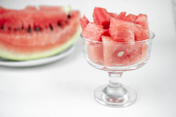 watermelon chopped pieces in a glass cup, summer fruit refreshment