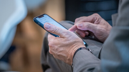 Businessman With Smartphone At Trade Fair