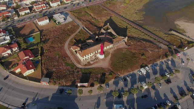 DRONE AERIAL FOOTAGE: The Farol de Esposende (Esposende Lighthouse) set in front of the Fort of Sao Joao Baptista de Esposende is situated at the mouth of Cavado river, north of Portugal.