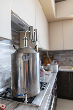 A large moonshine still stands on the gas stove