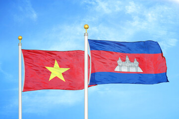 Vietnam and Cambodia  two flags on flagpoles and blue sky