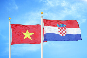 Vietnam and Croatia two flags on flagpoles and blue sky