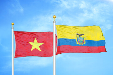 Vietnam and Ecuador two flags on flagpoles and blue sky