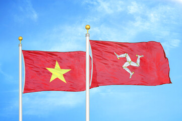 Vietnam and Isle of Mann two flags on flagpoles and blue sky