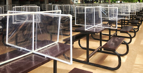 Plastic dividers at the food court tables.  So that people communicate safely during the COVID-19 epidemic