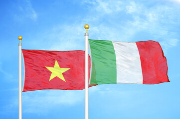 Vietnam and Italy two flags on flagpoles and blue sky