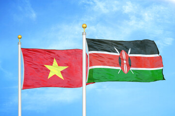Vietnam and Kenya two flags on flagpoles and blue sky