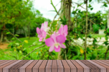 Empty wooden table top on blur abstact pink orchid flower products display or design 